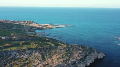 Aerial view of coastline with turquoise water, Malta.
