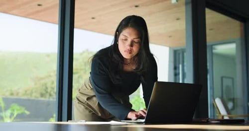 Business, woman and reading with laptop in office for proofreading article and update draft