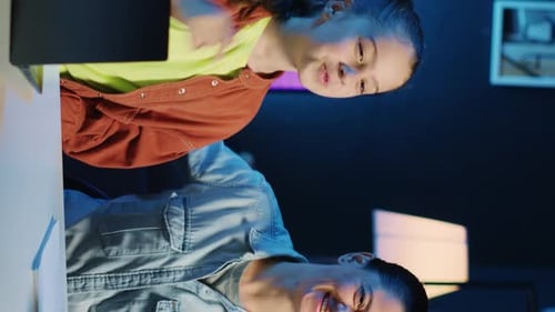 Woman and Girl Talking at Laptop