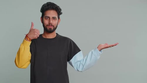 Indian Man Showing Thumbs Up Pointing Empty Place Advertising Area for Commercial Text Copy Space