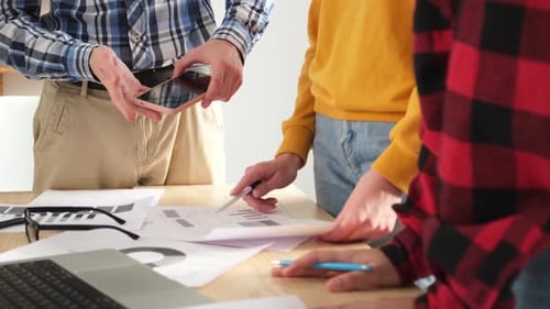 Team Analyzing Charts and Graphs in Office