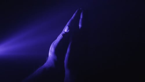 Hands Praying in Dark Awe