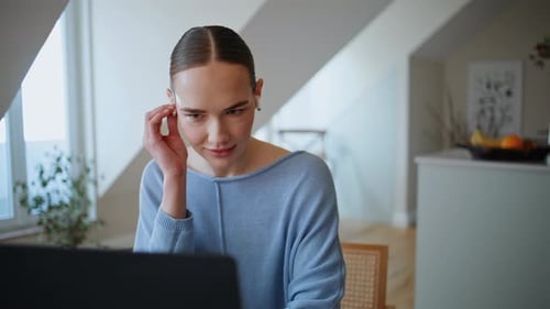 Young Adult Woman Using Laptop at Home