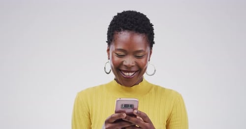 Woman Smiling While Using Cell Phone Indoors