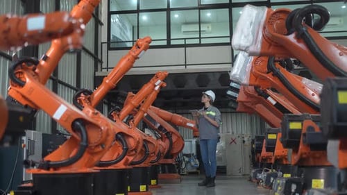 Engineer woman working inside robotic factory - Tech industry concept