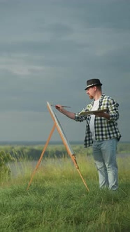 Artist Painting Woman in White Dress By Scenic Lakeside Field