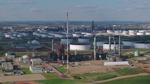 Vast Aerial Shot of Industrial Oil Refinery and Storage Tanks on a Clear Day