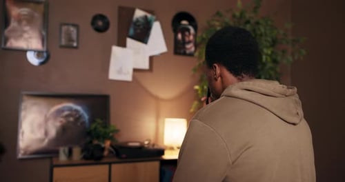 Young Adult Sings into Microphone at Home