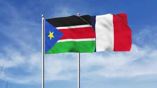 South Sudan and France National Flags Waving Against Blue Sky