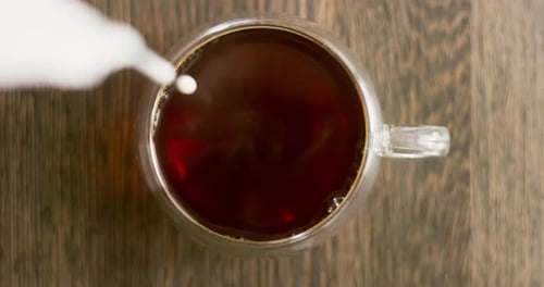 Milk Being Poured into Clear Mug of Coffee