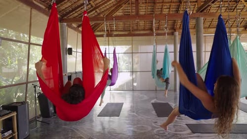 Close Up of Young Woman Hanging in the Yoga Hammock Upside Down