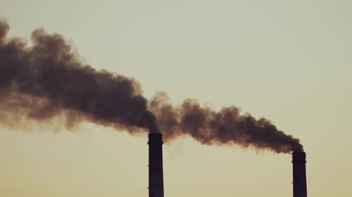 Black Smoke Billowing From Factory Chimneys During Sunset