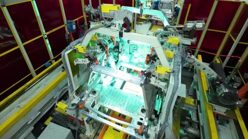 Factory technology robot arm works that assembles lithium or sodium batteries used in electric cars.