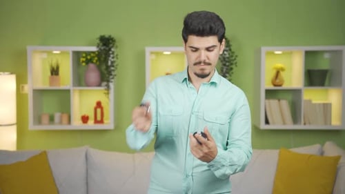 Man Demonstrating a Skincare Product Application at Home
