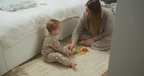 Baby Plays with Parent and Wooden Toy