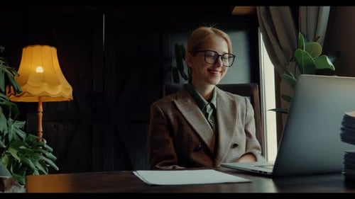 Young Woman Working on Laptop in Home Office