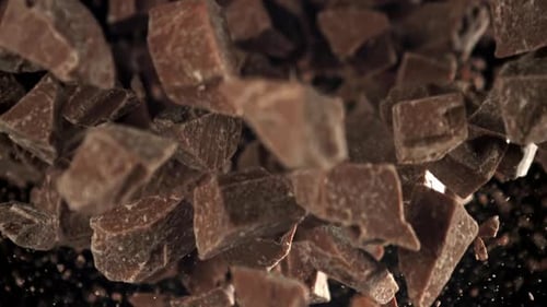 Dark Chocolate Pieces Falling in Slow Motion