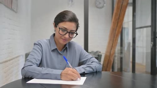 Indian Businesswoman Writing a Letter in Office