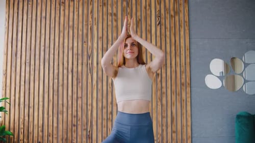 Woman Practicing Yoga in Living Room