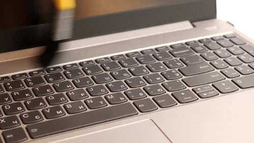 Keyboard Cleaning on Silver Laptop Computer Close Up