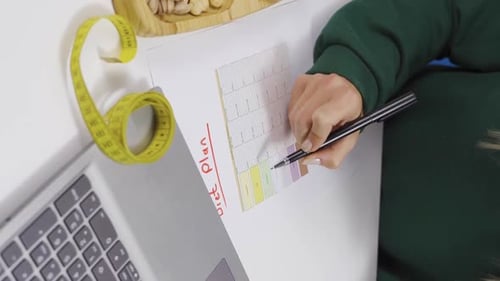 Woman Planning Diet with Laptop and Tape Measure