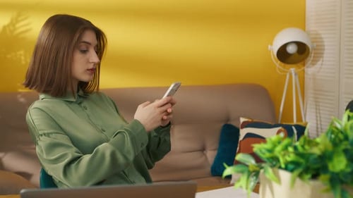 Woman Using Mobile Phone Indoors at Home