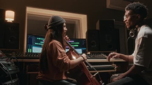 Girl Playing Cello in Recording Studio with Music Producer