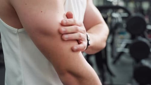 Body Builder Slapping Hands to Loosen Arm Muscles Post Workout
