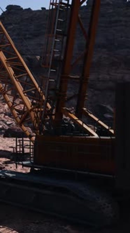 A Large Crane Sitting on Top of a Dirt Field