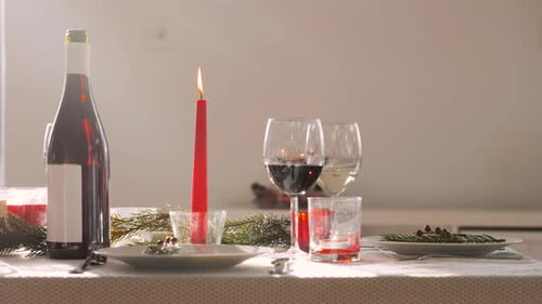 Festive table setting with wine, candles indoors