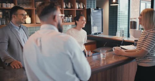 Businesspeople enjoying coffee and casual conversation during office break