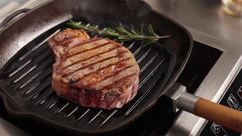 Chef cooks meat on the grill