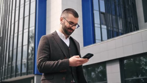 Smiling Business Man Boss Employee in Suit Use Smartphone Positive Emotion Outdoor Downtown City