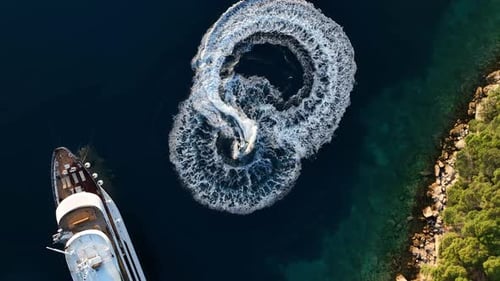 Speedboat Making Swirling Pattern In The Sea Next To Luxury Yacht In Kornati Island, Croatia. - aeri