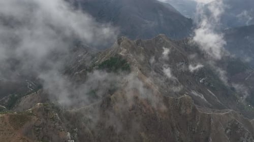 Aerial view of mountain peaks in clouds, Italy.