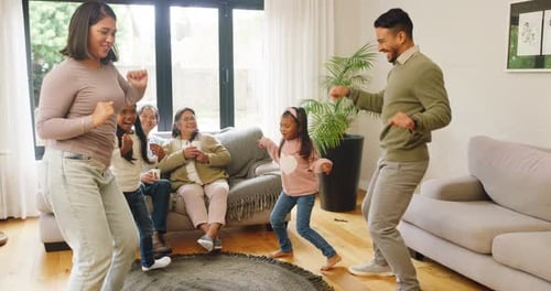 Family Dancing and Laughing Together in Living Room