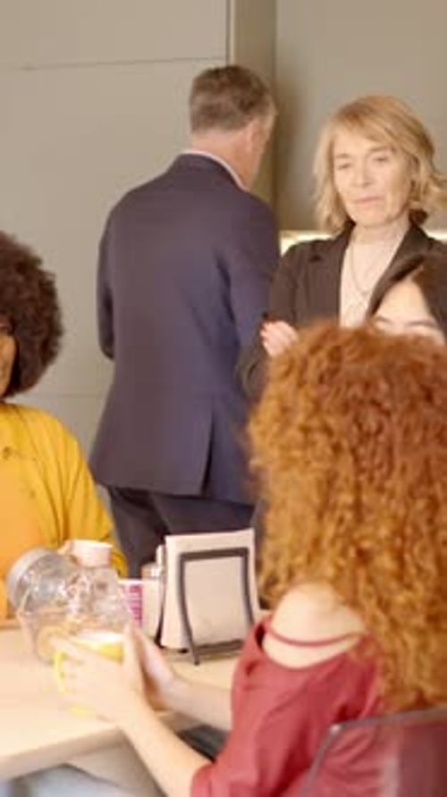 Adults Gathered at a Table in Office Setting