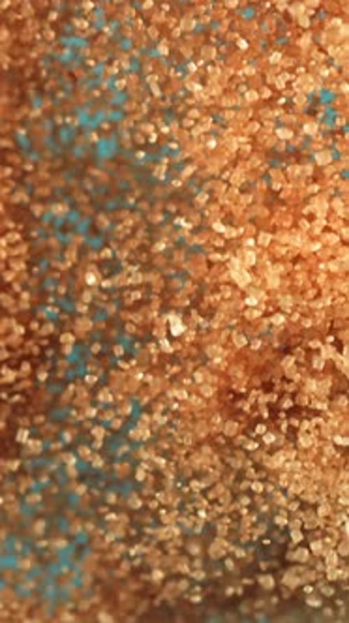 Cane Sugar Soars Against a Blue Background Filmed on a Highspeed Camera at 1000 Fps