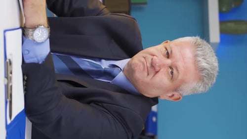 Man Talking in Office Wearing a Suit