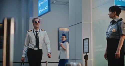 Airport Security Guard and Flight Crew Pass By