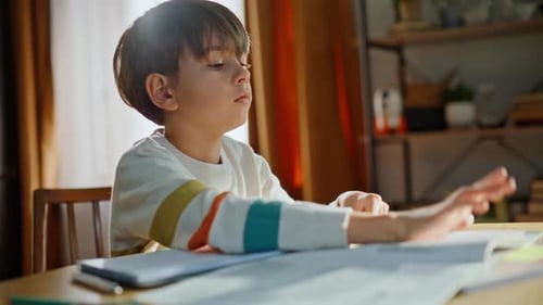 Young Boy Doing Homework at Table Indoors