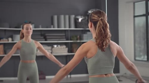 Woman Doing Dumbbell Lateral Raises in Home Gym