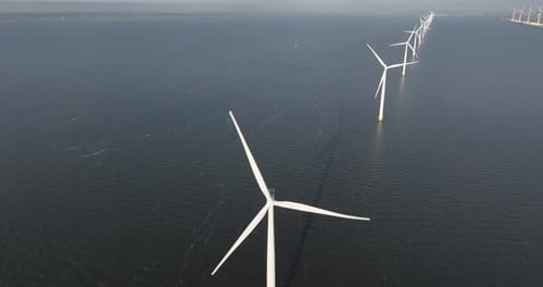 Wind turbine at open water, off shore wind mill park. Energy and sustainability system. Green power.