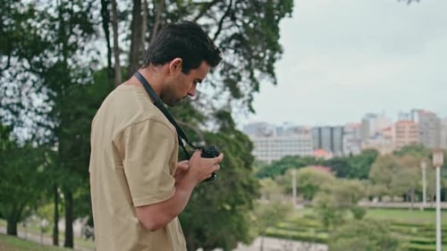 Young Photographer Shooting Cityscape on Professional Camera Close Up Man Photo