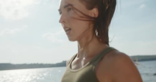 Athletic Woman Running in Place Outdoors by Lake