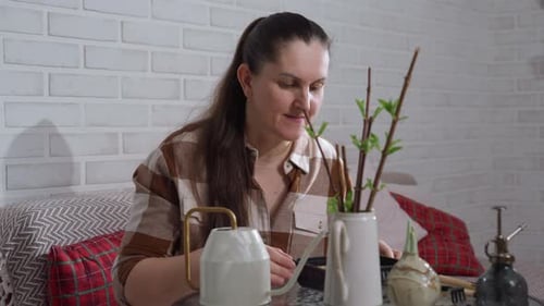 Woman Sniffs Tray Contents with Disapproval in Indoor Plant Setting