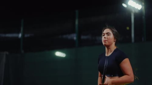 Female Tennis Player Hitting Ball on Indoor Court