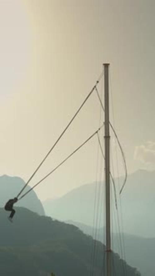 Bungee Swing Adventure Over Misty Mountains