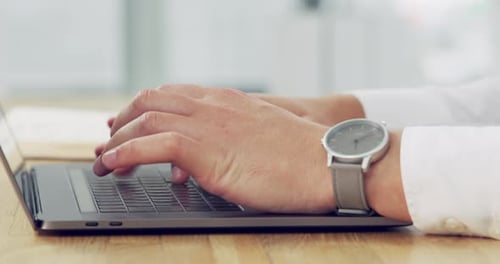 4k video footage of an unrecognisable businessman working on a laptop in an office