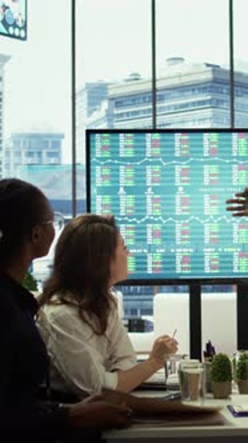 Vertical Video Business Associates Collaborating at the Conference Table in Boardroom